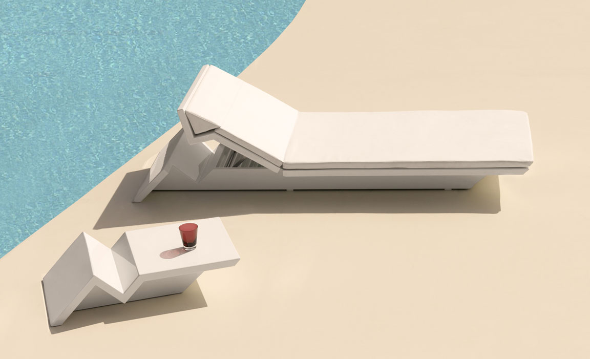 Plastic Resin LED Side Table — Modern white sun lounger and geometric side table with a drink by the poolside.