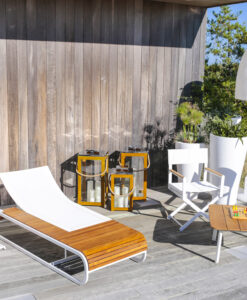 Dune Teak Square Coffee Table — Modern outdoor patio with white furniture, wood accents, and decorative lanterns