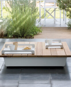 Manutti Air Coffee Table — Modern outdoor patio with sleek furniture and surrounding greenery