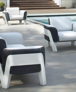 Bien Club Chair — Modern white and black outdoor furniture by a pool with potted plants