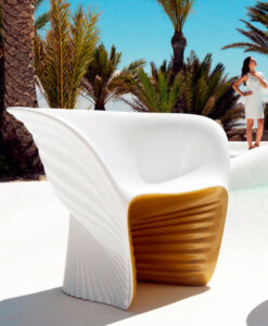 3100 2205a A person stands near palm trees behind a Modern LED Light White Club Chair on a white surface.