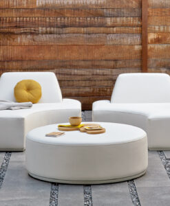 Modern outdoor furniture set with white chairs and table against wooden backdrop.