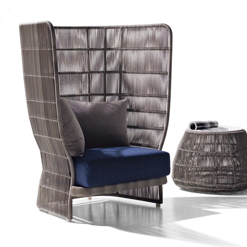 A modern high-back Aluminum Water Resistant Club Chair with a gray woven frame, blue cushion, alongside a matching woven side table