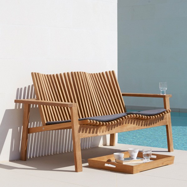 Amaze 2 Seater Sofa — a wooden bench next to a pool