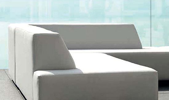 Amanda Sectional Sofa — Two white modern sofas in a bright room with a glass backdrop.