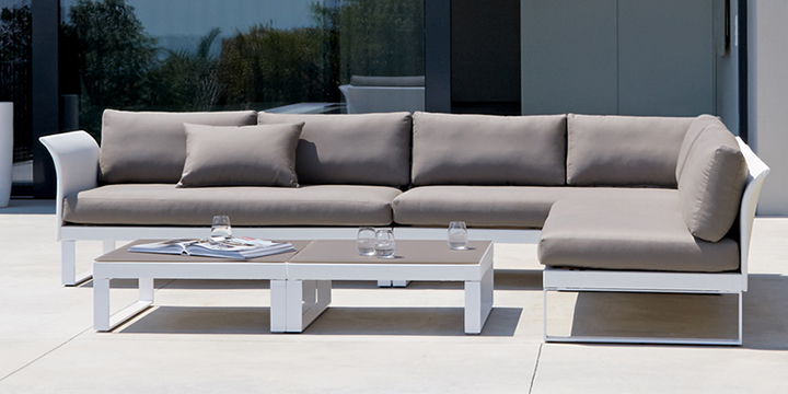 Modern Modular Sofa — Modern outdoor furniture set with aluminum modular sectional sofa and table on a patio.