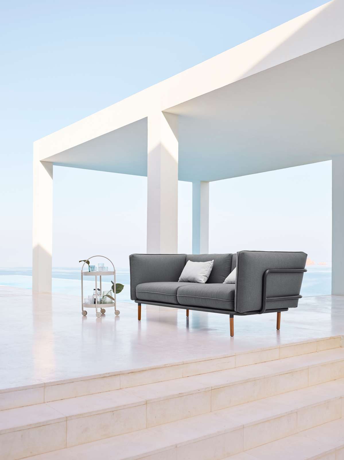 3 seater sofa — Modern gray sofa on a minimalist terrace