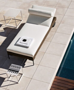 Contemporary Aluminum Rectangular Chaise Lounger & side tables on a tiled patio.