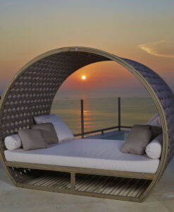 Moonlight Daybed — Round outdoor daybed overlooking a sunset at sea