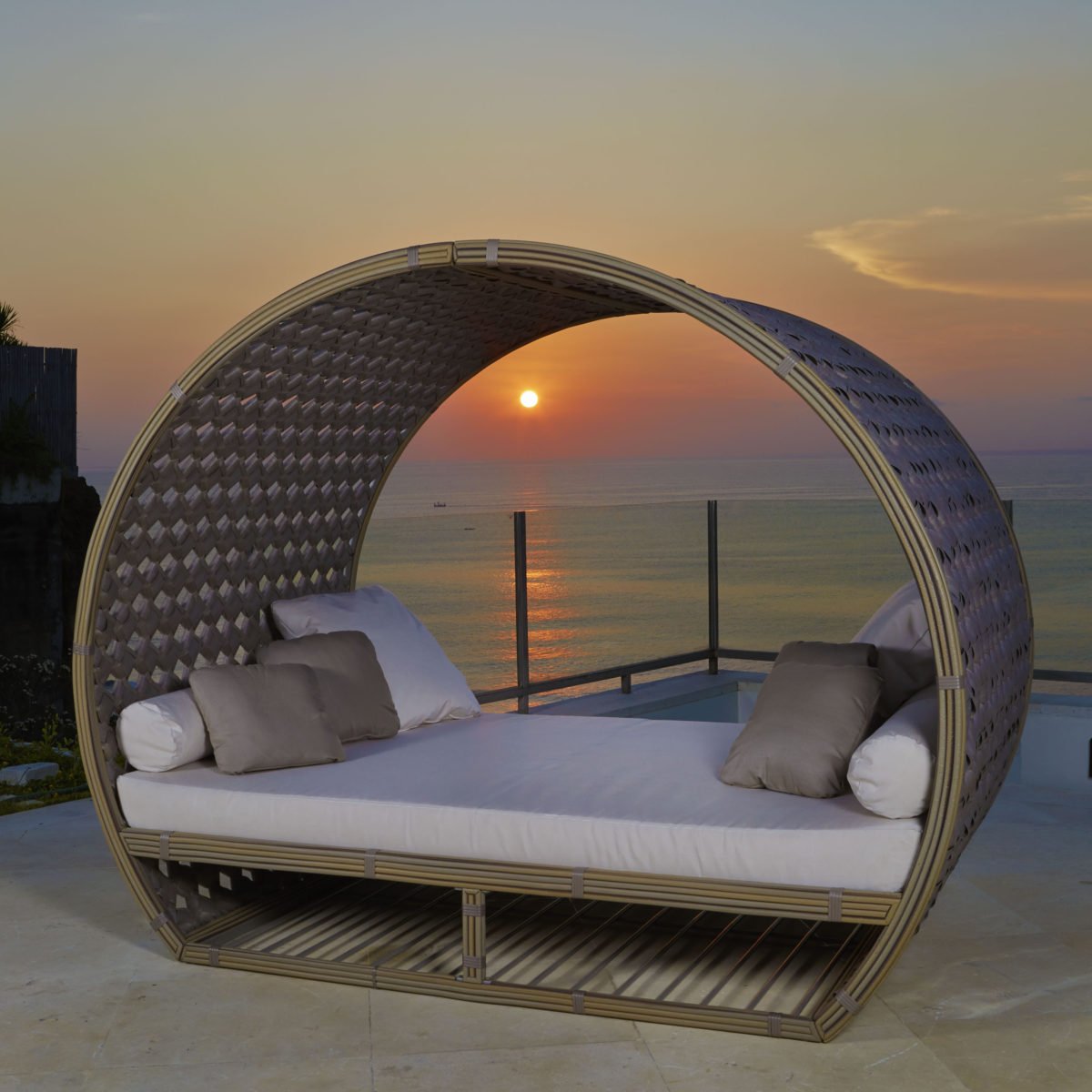 Moonlight Daybed — Round outdoor daybed overlooking a sunset at sea