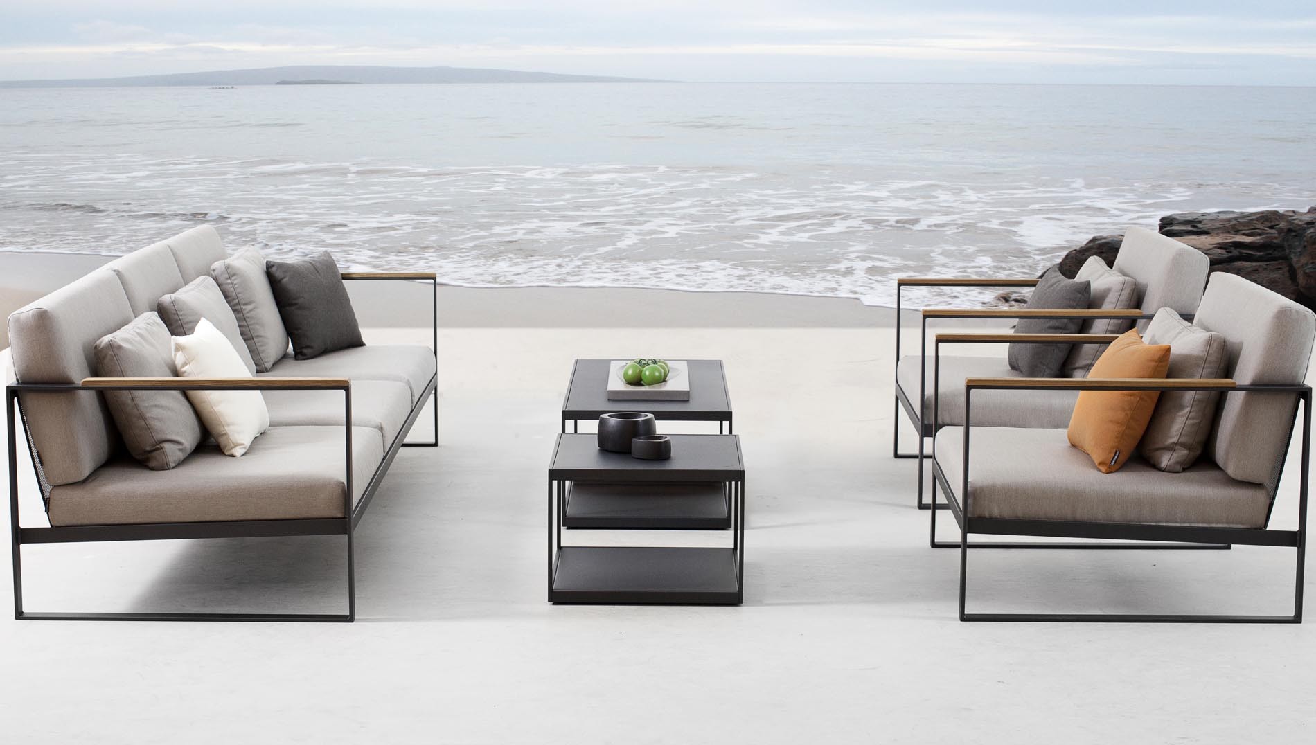 Outdoor patio furniture placed near a peaceful beach